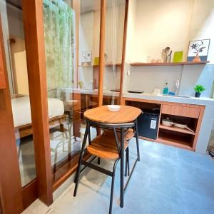 a small table and chairs in a small room at Jalak Merah in Canggu +25 photos