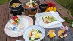 a table with plates of food and bowls of food at Tokachi Nauman Onsen Hotel arco in Makubetsu