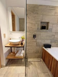 a bathroom with a tub and a sink and a shower at Iwana stay in Bogotá +30 photos