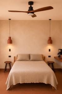 a bedroom with a bed with two tables at Ciruelo Tuyo in La Paz