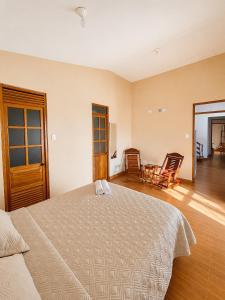 a bedroom with a bed and a table and chairs at Refugio Amazónico in San Martín
