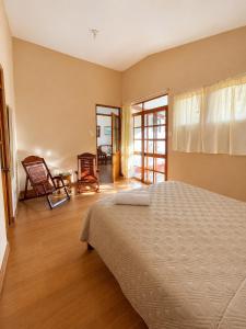 a bedroom with a bed and a living room at Refugio Amazónico in San Martín