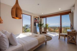 a bedroom with a large bed and a balcony at 1BR Ocean View Villa with Private Pool - Bingin in Bingin Beach +17 photos