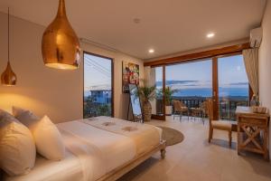 a bedroom with a large bed and a balcony at 1BR Ocean View Villa with Private Pool - Bingin in Bingin Beach