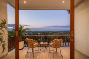 a balcony with three chairs and a table on a balcony at 1BR Ocean View Villa with Private Pool - Bingin in Bingin Beach