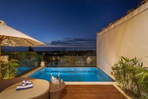 a swimming pool in a backyard with a table and a table at 1BR Ocean View Villa with Private Pool - Bingin in Bingin Beach