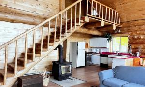 a kitchen and living room with a stove in a cabin at Nimpo Lake Resort in Nimpo Lake