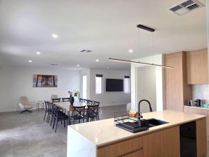 a kitchen and living room with a table and chairs at Belless at Moonta Bay in Port Moonta