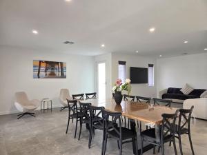 a living room with a table and chairs and a couch at Belless at Moonta Bay in Port Moonta