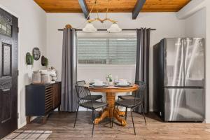 a kitchen with a table with chairs and a refrigerator at Brunos Bungalow in Big Bear Lake