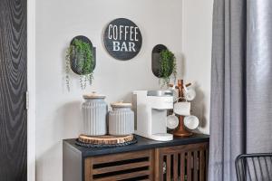 a table with a coffee bar sign on a wall at Brunos Bungalow in Big Bear Lake