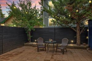 a patio with two chairs and a table in front of a house at Brunos Bungalow in Big Bear Lake