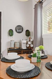 a dining room table with white plates on it at Brunos Bungalow in Big Bear Lake +28 photos