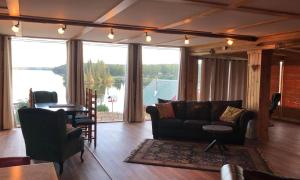 a living room with a couch and a view of a lake at Nimpo Lake Resort in Nimpo Lake
