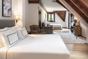 a bedroom with a large bed and a living room at Meliá de Tredós in Tredós