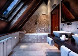 a bathroom with a tub and a sink at Meliá de Tredós in Tredós +38 photos