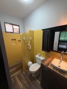 a bathroom with a toilet and a sink at Casa Pacífico Esterillos in Esterillos +38 photos
