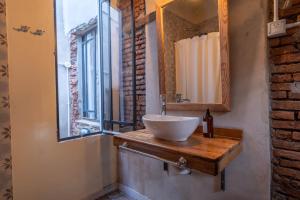a bathroom with a sink and a mirror at La Piamonte 1903 in Azcuénaga