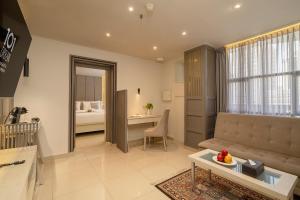 a living room with a couch and a table at 1O1 URBAN Jakarta Thamrin in Jakarta