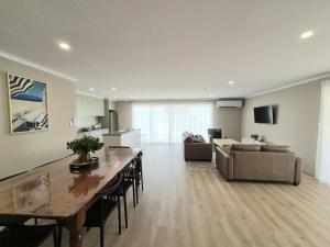 a large living room with a table and a couch at Ramsay House in Port Vincent