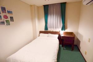 a small bedroom with a bed and a desk at Hotel Nomad - Vacation STAY 73941v in Hitachi