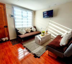 a living room with a couch and a table at Julieta House in Puerto Natales
