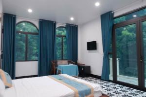 a bedroom with a bed and a large window at Cat Ba Love House in Cat Ba