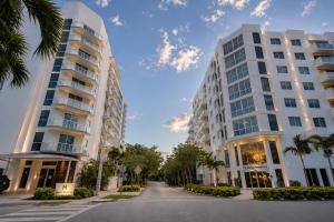 two tall buildings on a street with palm trees at Habitat Residence in Miami