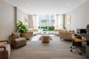 a lobby with a waiting room with couches and chairs at Habitat Residence in Miami