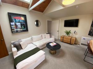 a living room with a white couch and a table at Resort Arrowtown in Arrowtown