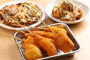 a table with two plates of food and two plates of food at Dormy Inn Premium Namba ANNEX Natural Hot Spring in Osaka
