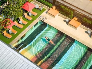 an overhead view of a person swimming in a swimming pool at DoubleTree by Hilton Sukhumvit Bangkok in Bangkok