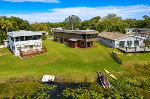 an aerial view of a house and a boat in the water at Cozy Lakefront Home in Lake Wales