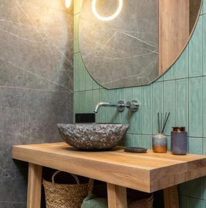 a bathroom with a bowl sink on a wooden table at Wake Up to the Ocean - Beachfront Studio in Hauula