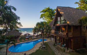 an aerial view of a resort with a swimming pool and the ocean at Mar Villa Eco Lodge Surf & Kite Perla Marina by Encuentro Beach in Sosúa