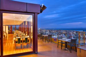 a restaurant with tables and chairs on a balcony at Grand Madrid Hotel in Istanbul