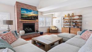 a living room with a couch and a fireplace at Welahpu Beach in Cape May