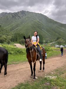 a woman riding a horse on a dirt road at Dream house in Türgen
