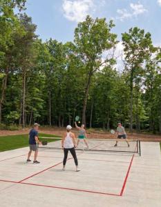 a group of people playing tennis on a tennis court at Fern Cottage in Menlo GA in Rising Fawn