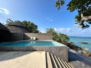 a swimming pool with a view of the ocean at Black Pearl Resort in Espiritu Santo