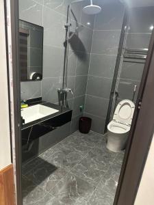 a bathroom with a shower and a toilet and a sink at Ruby 25 Hotel in Hà Ðông
