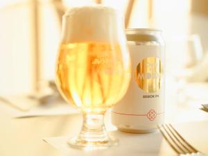 a glass of champagne next to a can of beer at Over the MOON in Awaji