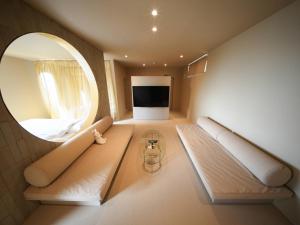 a room with a large mirror and a couch at Over the MOON in Awaji