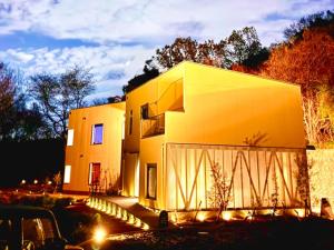 a house with a yellow facade at night at Over the MOON in Awaji