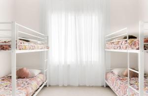 a bedroom with two bunk beds and a window at The Stately Way in Wallaroo