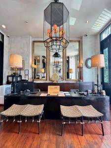a salon with two chairs and a large mirror at 99 The Gallery Hotel in Chiang Mai