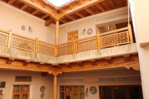 a balcony in a building with wooden railings at Hotel Nazira & Azizbek 2 in Bukhara