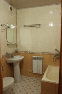 a bathroom with a sink and a toilet and a tub at Hotel Nazira & Azizbek 2 in Bukhara
