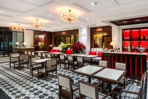 a restaurant with tables and chairs and a bar at Diamond Hotel Yen Bai in Yên Bái