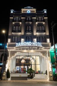 a sign on the front of a diamond hotel at night at Diamond Hotel Yen Bai in Yên Bái